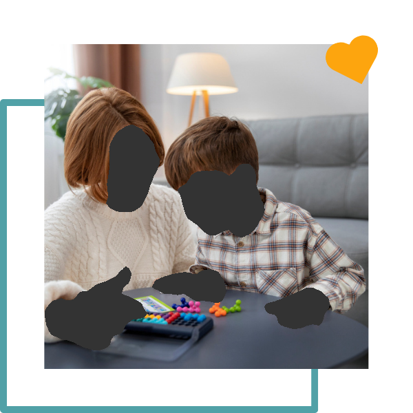 Woman and child playing a board game together at a table indoors.