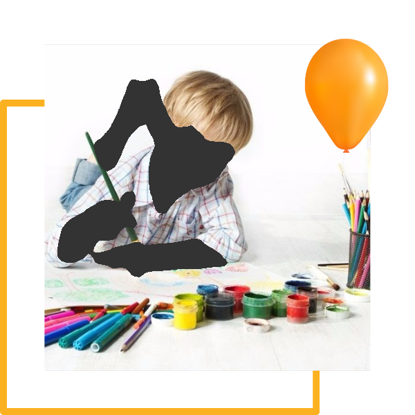 Boy lying on floor painting, orange balloon, paint supplies.