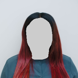 Woman with dark hair, red highlights, smiling, wearing a teal top, against a white background.