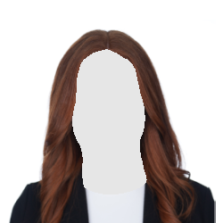 Woman with red hair, smiling in a black blazer and white shirt, against a white background.