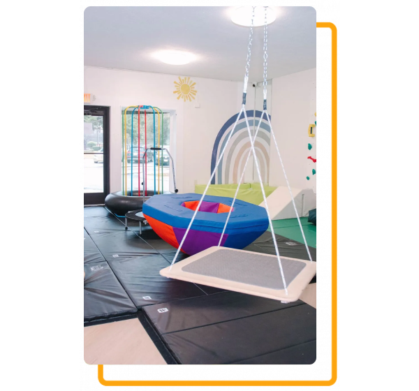 A room with a swing hanging from the ceiling