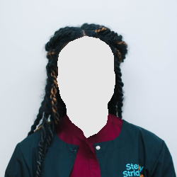 Woman with braided hair, smiling, wearing a burgundy shirt and dark jacket with the words 