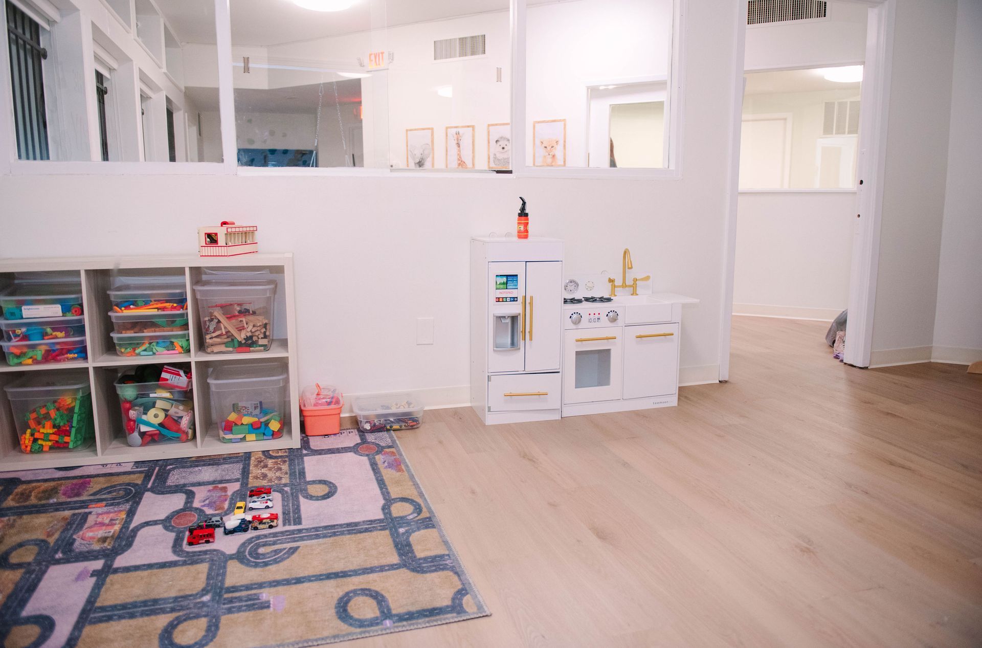 A room filled with lots of toys and a play kitchen.