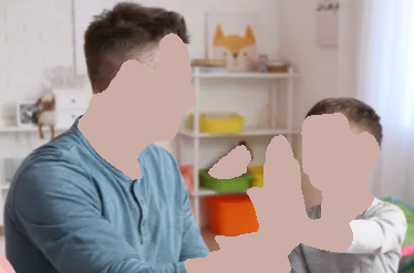 Man and child give each other a high five in a child's bedroom. Both smile.