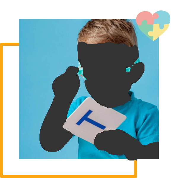 Boy wearing glasses looking at card with letter 