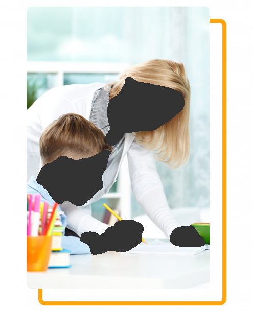 Woman assisting a child with writing at a desk, smiling.